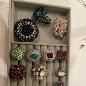 Collection of decorative rings in various styles and colors.